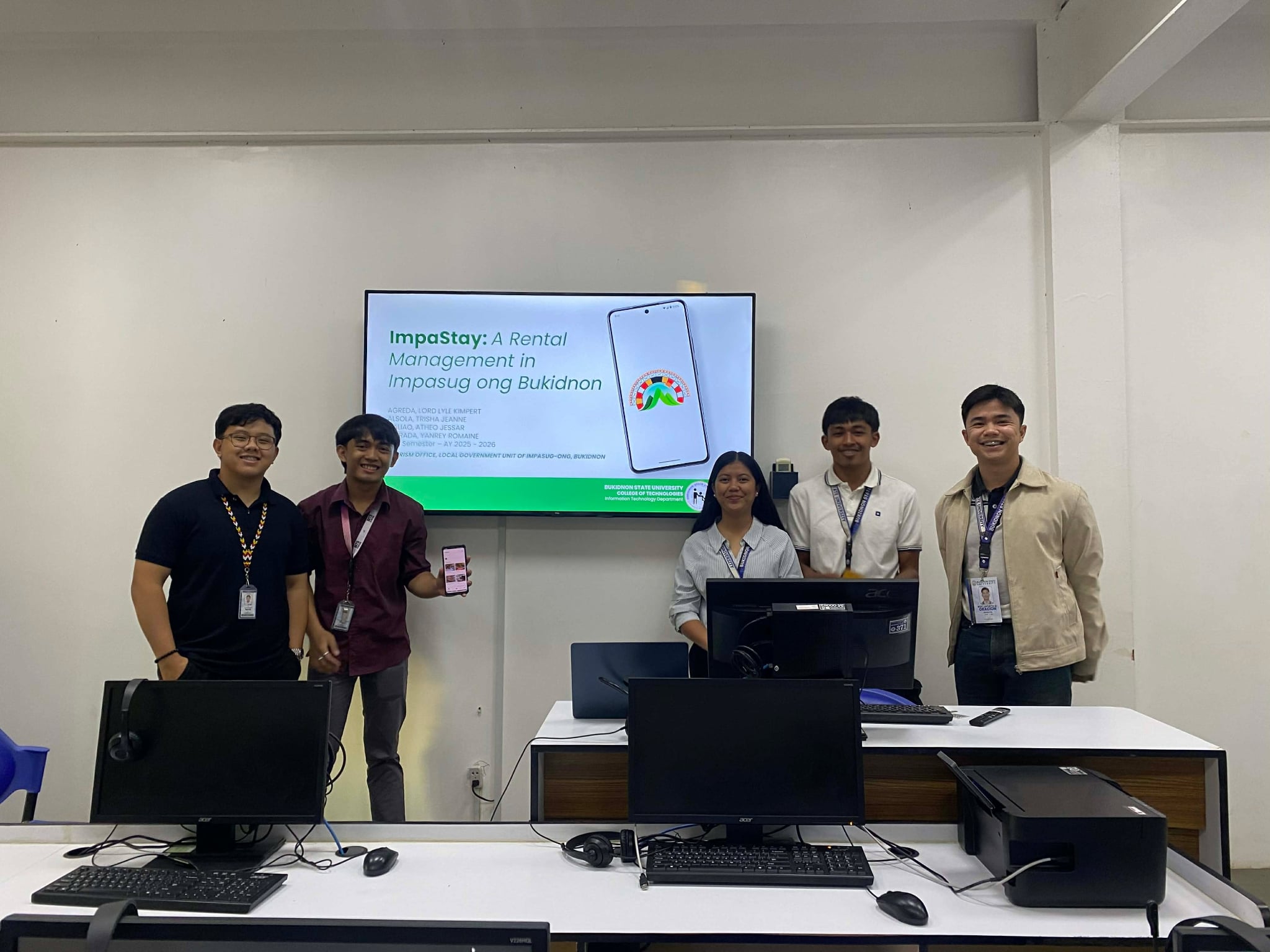 Lyle Agreda presenting the ImpaStay rental management system with a Bukidnon State University team