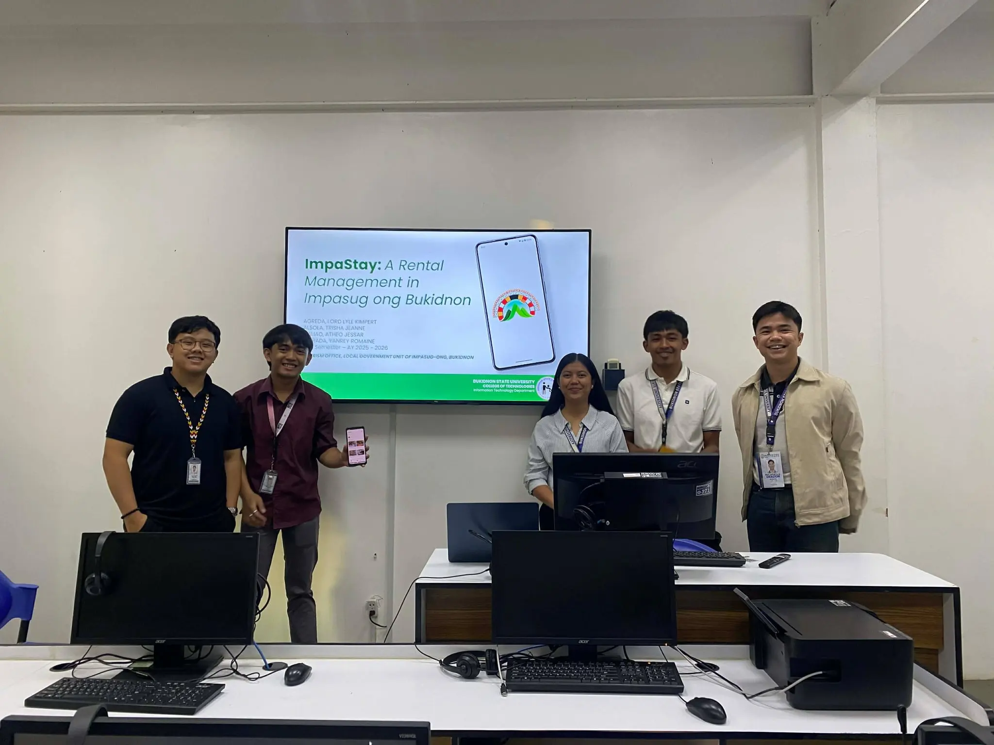 Lyle Agreda presenting a rental management system with a Bukidnon State University team