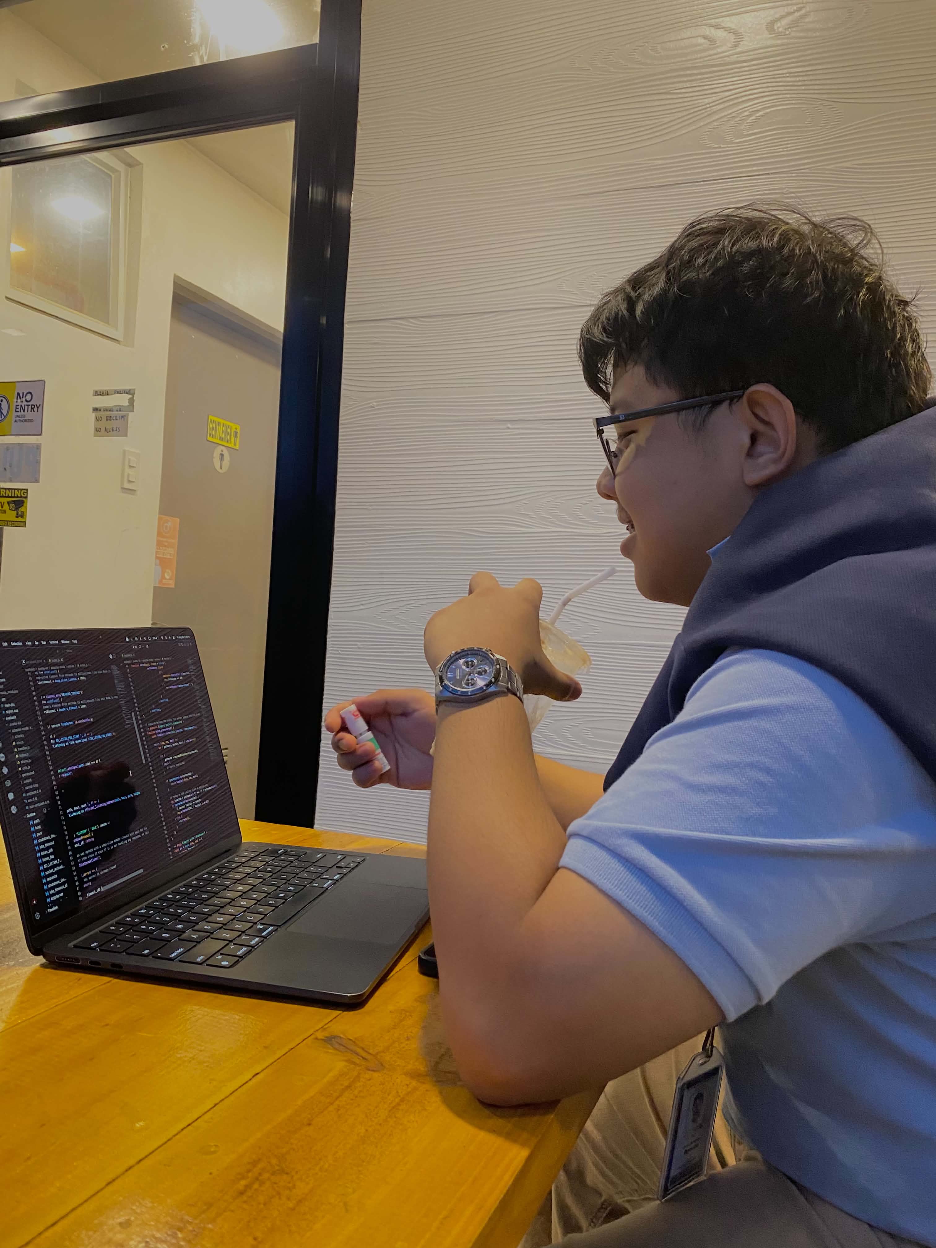 Lyle Agreda developing software on a laptop in Bukidnon
