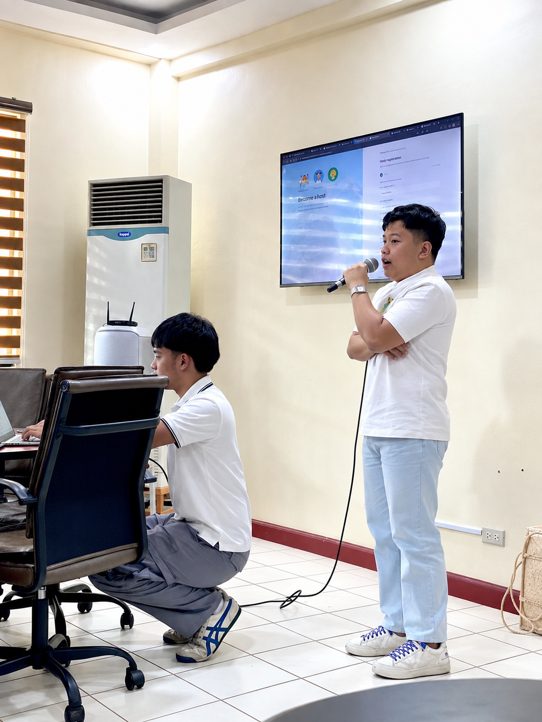 Lyle Agreda presenting a tourism accommodation platform during a project demonstration in Bukidnon